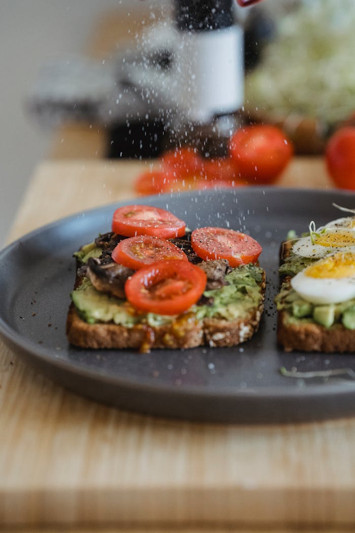 awards-img Delicious avocado toast topped with cherry tomatoes and a boiled egg, perfect for breakfast.
